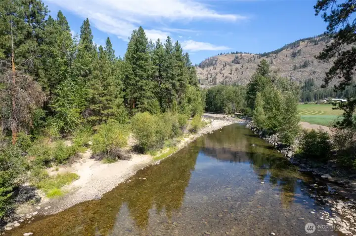A rare riverfront parcel north of Winthrop! Looking north, property shores on the left.  A quiet and private shore to spend your days in the Methow Valley.