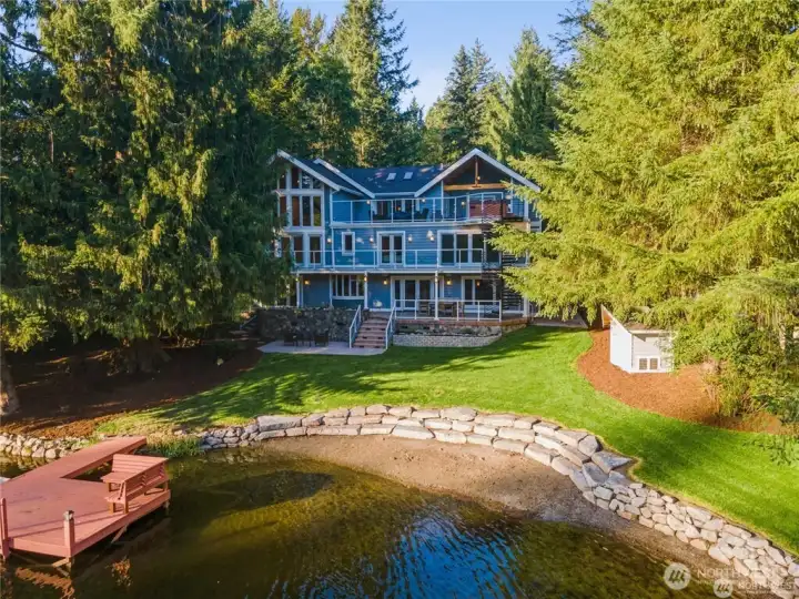 Coveted Lake Marcel Custom Waterfront Home with 135' of Waterfront & Bay Living. Professionally Designed terraced rockery wall for entertaining.