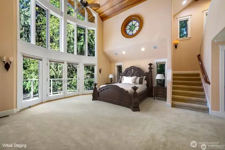 Dramatic two story Primary Bedroom. Bow to Bay wall of windows called the Wedding Cake.