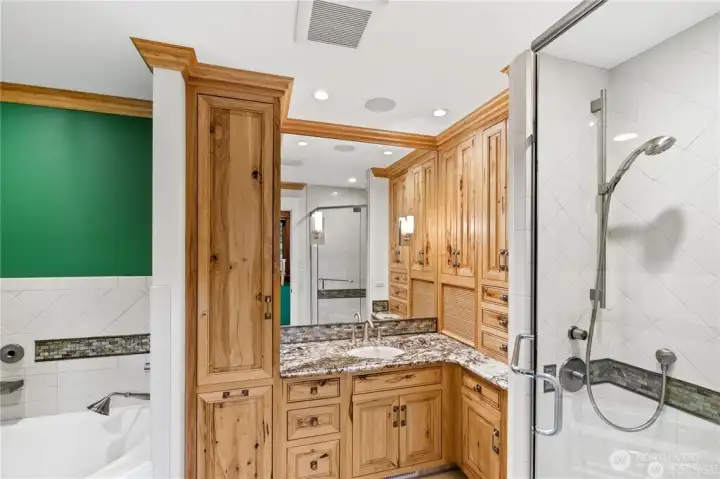 Separate Childrens full bathroom with heated flooring. Canyon Creek Hickory cabinets with crown molding & White Tiger granite counters. Tambour door storage area.