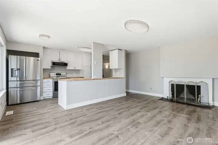 Spacious eating dining area with fireplace off kitchen.