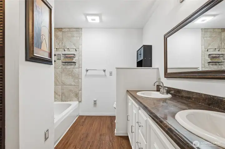 Private en-suite featuring double sinks and tile shower.