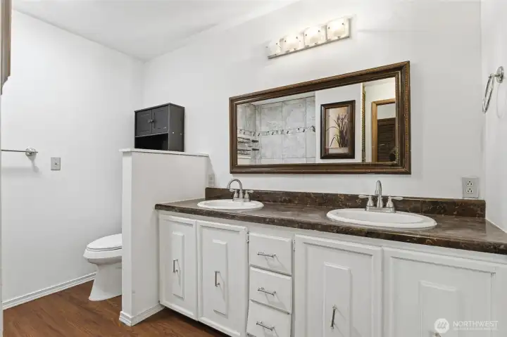 Double sinks and framed mirror.