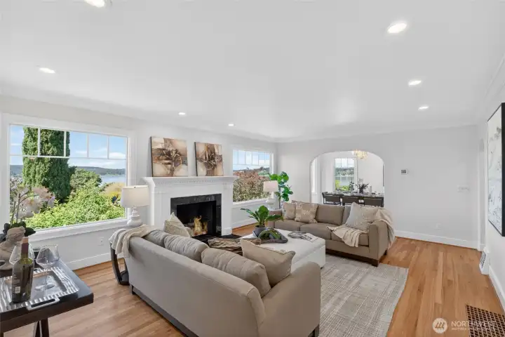 Living room with gas fireplace looking out at the water.