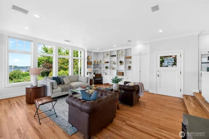 Front room showcasing the stylish built-ins. Door leads up path to 3 car garage - one slot of RV height.