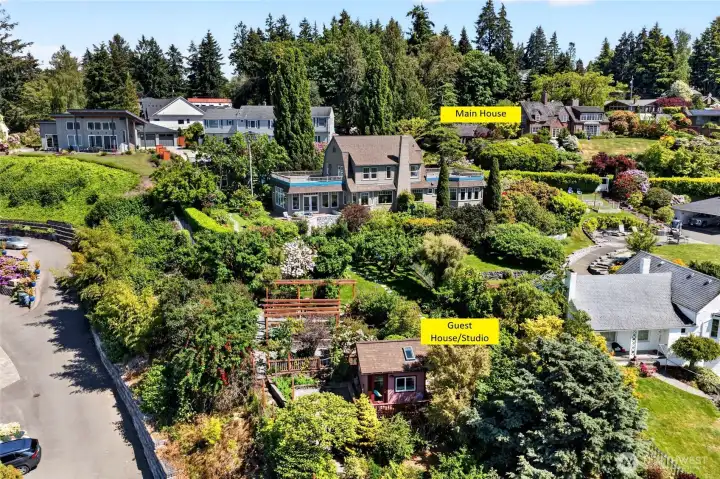 Shows the Main House and the Guest Cottage/Studio down the hill. Mature and lush garden is highlighted between the two.