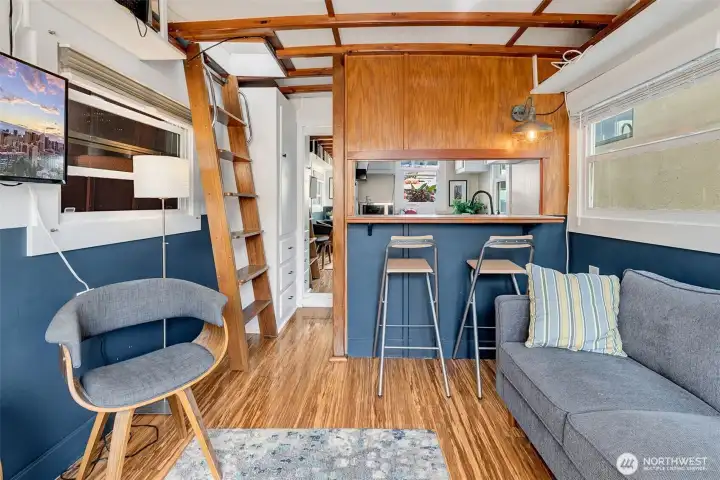 Charming living room and kitchen counter with a pass through space from the kitchen.