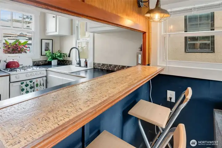 Kitchen counter, tiled backsplash, and a gas stove.