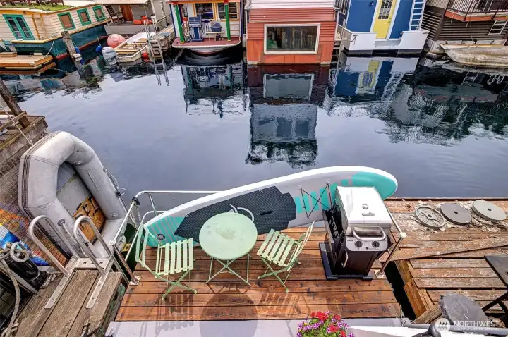 Rear deck with eating space, grill, and a dingy that's included.