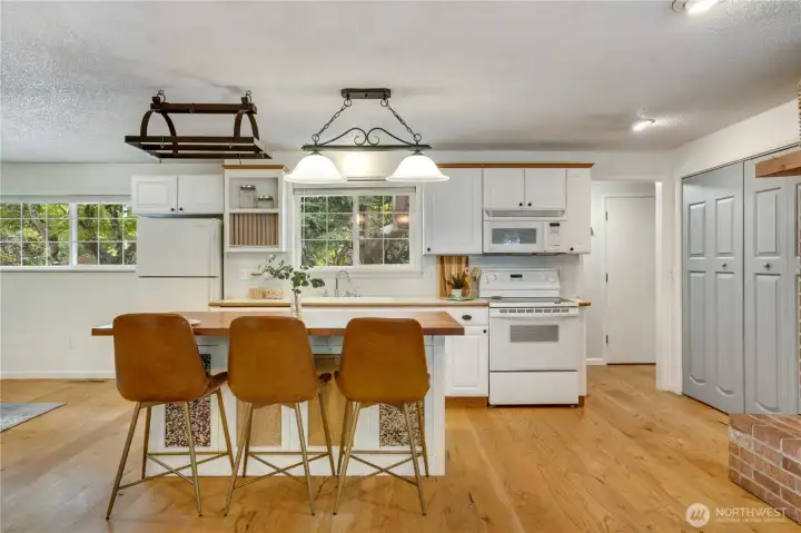 The island offers additional seating and storage, while the pantry keeps kitchen essentials close at hand. The island offers additional seating and storage, while the pantry keeps kitchen essentials close at hand.