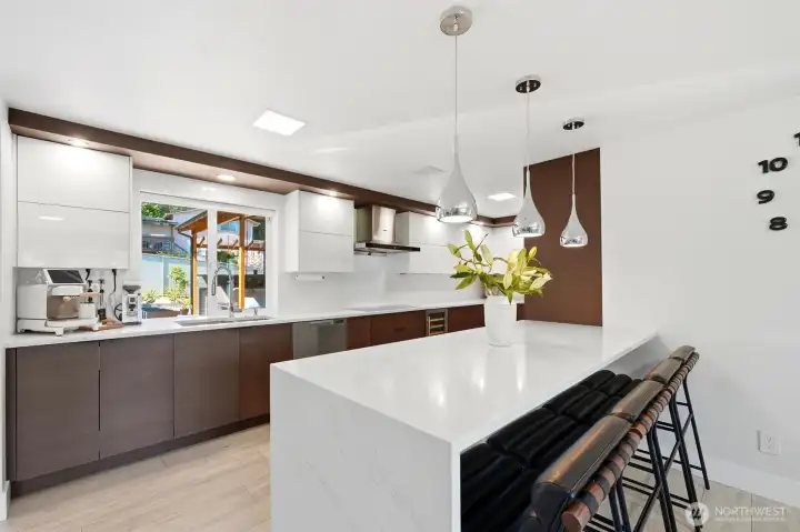 Remodeled kitchen with quartz countertops and beautiful custom-built cabinetry.