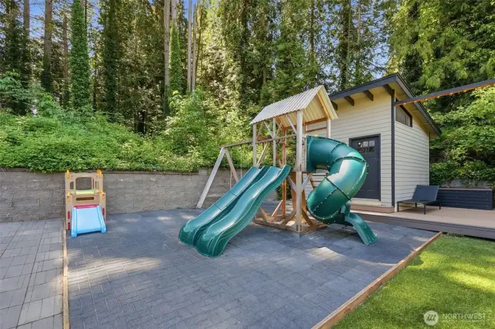 Dedicated playground area within the fenced yard.