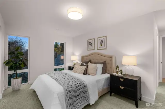 Your retreat awaits! This chic bedroom combines comfort and sophistication with contemporary design and picturesque window views.