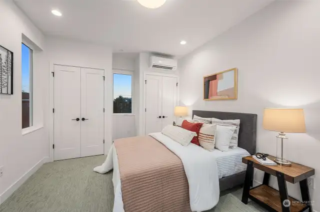 Step into a peaceful retreat where modern design meets cozy comfort. This sunlit bedroom is your sanctuary, complete with ample closet space and serene views.