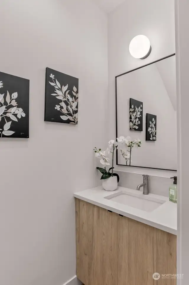 A chic and functional powder room with refined touches and modern fixtures to impress your guests.