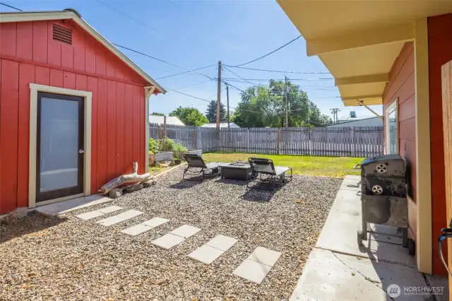Studio, fire pit area, covered walkways, and large fenced yard make this a desirable rental home.