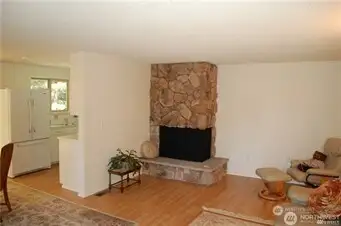 The living room has a fireplace and hardwood floor. Nice open floor plan.
