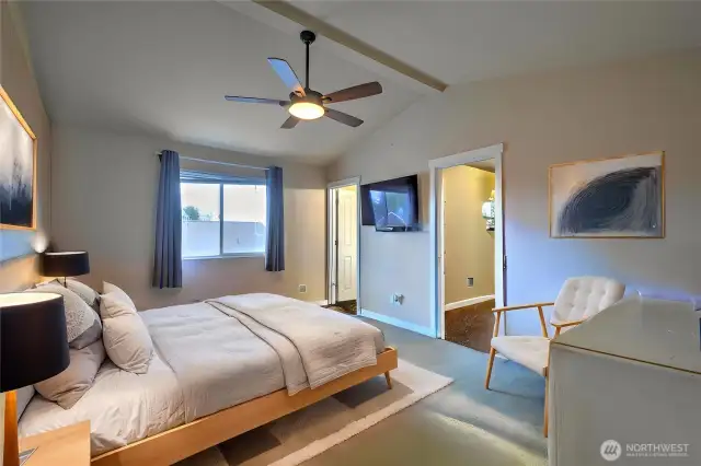 Large primary bedroom with vaulted ceilings and huge closet.