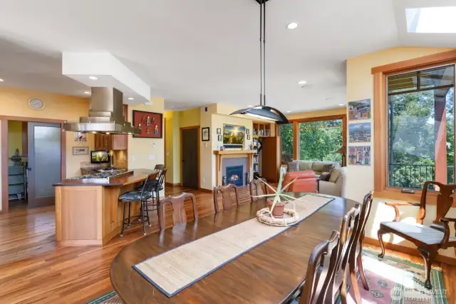 Great view of the dining area to the bookshelf, to the six burner propane stove, and to the walk-in pantry.