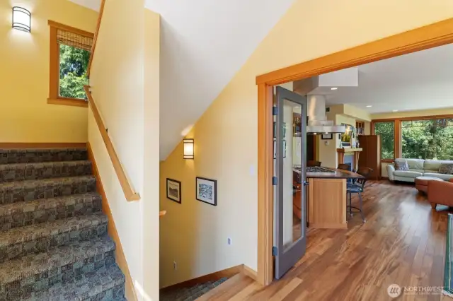 Stairs on the left head to the primary suite. The stairs on the right lead to the other bedrooms, full bath, laundry, and entry from the 2 car garage.