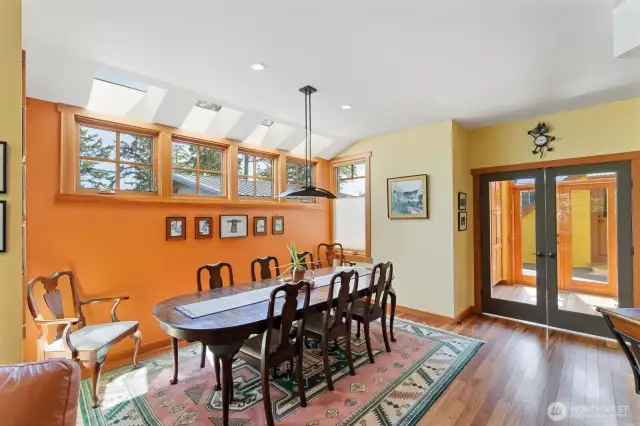 Light filled home, large dining area. Glass doors lead to the stair landing, out to the private deck and the attic space above the garage