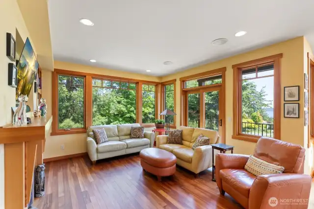 Living room with deck off to the right.  Double doors open to the balcony and protect view.