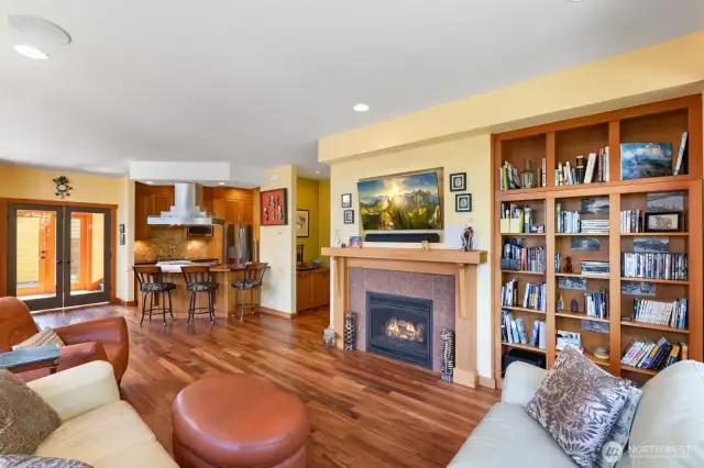 Tiger wood floors, propane fireplace, book shelves to the right
