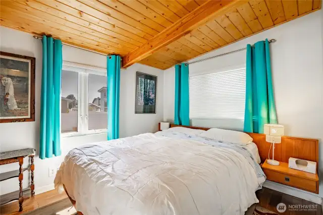 Extra room addition that is being utilized as a bedroom. Knotty pine ceiling and engineered flooring.