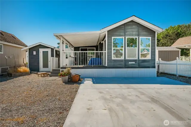 Nice parking, vinyl siding, built in 2001 and is 500 sq. ft. +/-. It is utilized as a 2 bedroom and 1 bath. Covered composite deck area and generous outbuilding.
