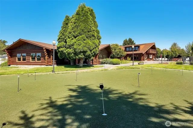 Putting green. There are three buildings side by side.