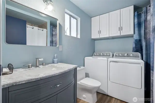 Upgraded entry level bathroom/utility room with tub and shower.