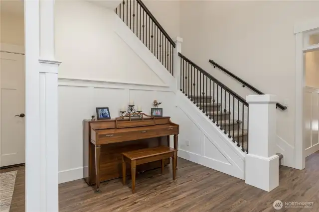 Elegant touches throughout, including wainscoting and iron balusters