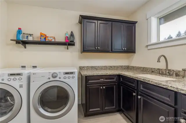 Convenient upstairs laundry room with utility sink