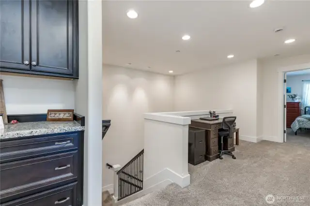 Loft with built-in cabinetry and a flex space for reading nook, office space, etc.