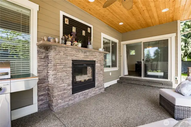 Covered patio has double-sided fireplace