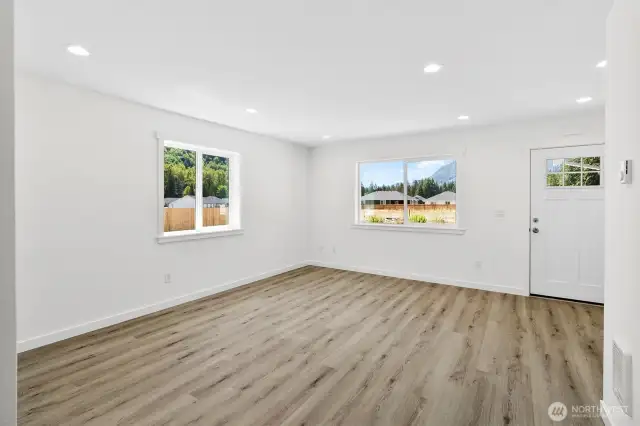 View of front door from far side of living room.