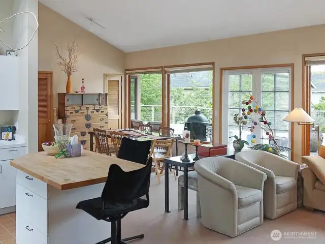 Once inside, you'll find vaulted ceilings, french doors that open wide to the back deck beyond, AIR CONDITIONING, and a kitchen with center island.