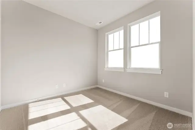Main floor bedroom with so much natural light.  Photos are for representational purposes only. Colors and finishes may vary