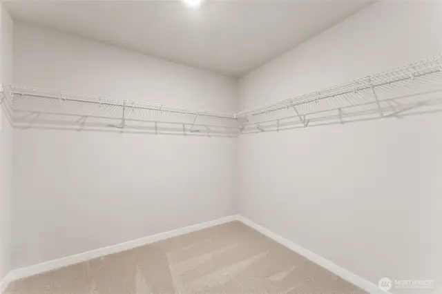 Primary closet.  Photos are for representational purposes only. Colors and finishes may vary