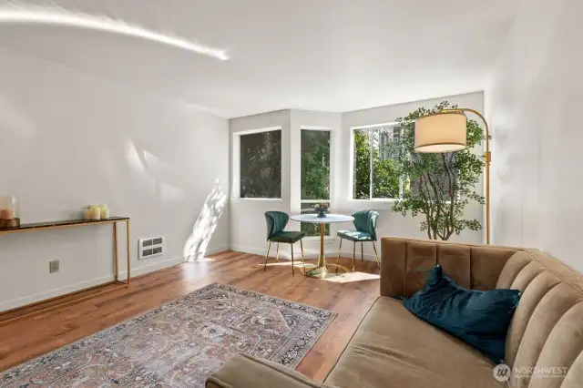 Sunlight dapples in, softened by a canopy of lush greenery just beyond the glass, filling the space with the quiet beauty of a canopy retreat