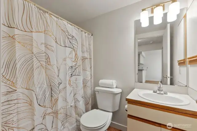 The bathroom that's been thoughtfully refreshed—where modern touches meet classic charm—you'll find stylish new fixtures creating a space that’s as inviting as it is practical.