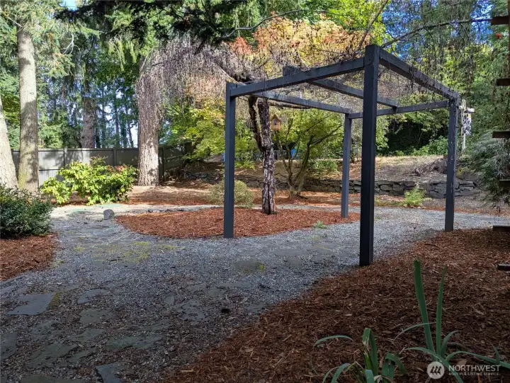 The view from the front door shows the low maintenance yard, with gardens including Japanese maple, weeping willow and Douglas Fir, and beyond is the dead-end street with very little traffic.