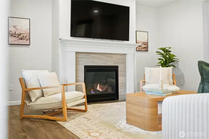 Great room on main level has cozy gas fireplace and large TV