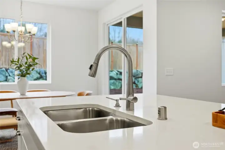 Great kitchen island with a view to dining area, great room and back yard, with plenty of natural light