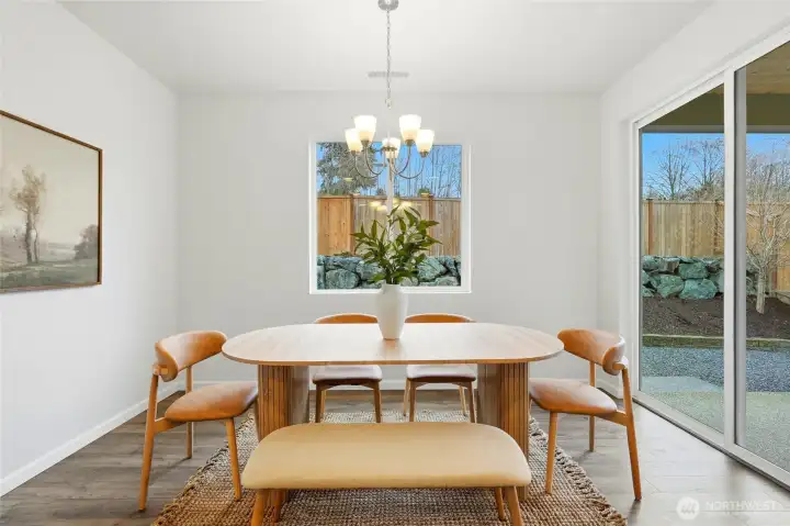 Kitchen and dining area open to fenced back yard and covered patio
