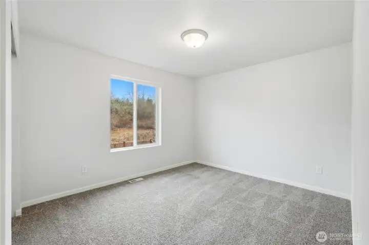 2nd bedroom on upper level overlooks backyard and open space