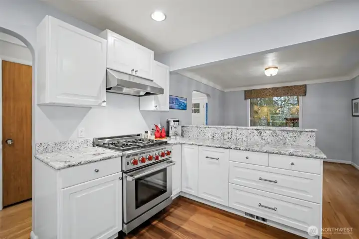 Bright white cabinetry is complemented by gorgeous granite countertops.