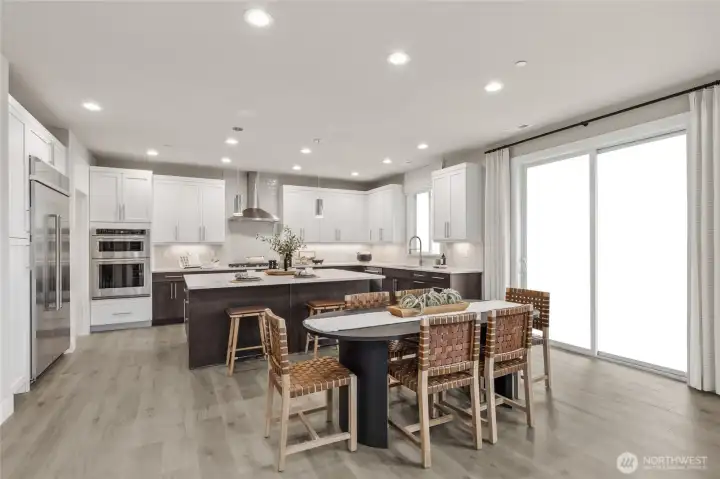 Over view of the spacious gourmet kitchen and separate eating area. Photo is representational. Actual home is under construction and materials, colors, and finishes will vary. See site agent for details.