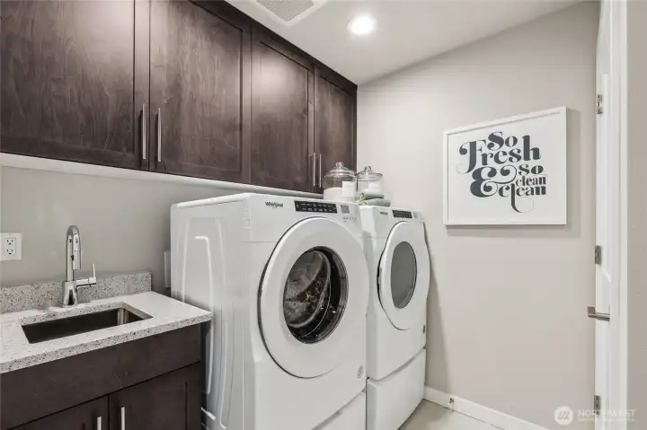 Upstairs laundry room with sink. Photo is representational. Actual home is under construction and materials, colors, and finishes will vary. See site agent for details.