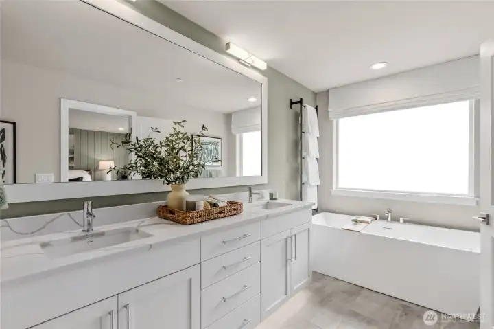 Primary bathroom with double sink and standalone tub.  Photo is representational. Actual home is under construction and materials, colors, and finishes will vary. See site agent for details.